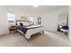 Spacious main bedroom with multiple windows and a decorative mirror at 8480 Arriba Dr, Littleton, CO 80125