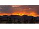 Majestic sunset view with vivid colors painting the sky over the mountains, creating a serene ambiance at 8480 Arriba Dr, Littleton, CO 80125