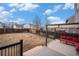 Large backyard with deck, pergola, and wooden fence at 11455 River Run Pkwy, Commerce City, CO 80640