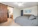 Main bedroom with barn door to bathroom and dresser at 11455 River Run Pkwy, Commerce City, CO 80640