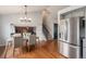 Dining area with hardwood floors, a table for four and a view to the kitchen at 11455 River Run Pkwy, Commerce City, CO 80640