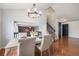 Bright dining room features a table with four chairs, hardwood floors, and a modern chandelier at 11455 River Run Pkwy, Commerce City, CO 80640