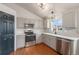 Modern kitchen featuring stainless steel appliances and light-colored cabinetry at 11455 River Run Pkwy, Commerce City, CO 80640