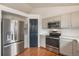 Kitchen with stainless steel appliances and light gray cabinets at 11455 River Run Pkwy, Commerce City, CO 80640