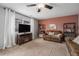 Living room with two leather couches, a fireplace, and accent wall at 11455 River Run Pkwy, Commerce City, CO 80640