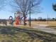 Park playground with play structures and a path at 11455 River Run Pkwy, Commerce City, CO 80640