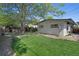 Expansive backyard featuring a lush lawn and mature landscaping including a hot tub at 9400 Ridge Rd, Arvada, CO 80002