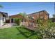 Inviting backyard featuring a pergola, lush lawn, modern shed, and charming outdoor seating area at 9400 Ridge Rd, Arvada, CO 80002