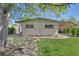 Inviting backyard featuring a swing hanging from a mature tree and an outdoor dining area at 9400 Ridge Rd, Arvada, CO 80002