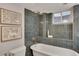 Bathroom featuring a soaking tub with tile surround, a shower head, and neutral decor at 9400 Ridge Rd, Arvada, CO 80002