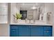 Bathroom with a blue vanity, a large mirror, and a bright counter space at 9400 Ridge Rd, Arvada, CO 80002