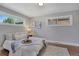 Comfortable bedroom features natural light from windows and wood floors at 9400 Ridge Rd, Arvada, CO 80002