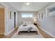 Bright bedroom with hardwood floors, neutral decor, and natural light, and a comfortable bed at 9400 Ridge Rd, Arvada, CO 80002