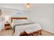 Bright bedroom featuring a comfortable bed, light hardwood floors, and a neutral decor scheme at 9400 Ridge Rd, Arvada, CO 80002