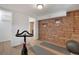 Functional exercise room with exposed brick wall, workout bike, and space for yoga at 9400 Ridge Rd, Arvada, CO 80002
