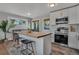 Modern kitchen with stainless steel appliances, white cabinets, and cozy breakfast nook in neutral colors at 9400 Ridge Rd, Arvada, CO 80002