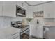Updated kitchen featuring white cabinets, quartz counters, a modern cooktop, and stainless steel appliances at 9400 Ridge Rd, Arvada, CO 80002