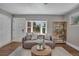 Comfortable living room showcasing a plush sofa, decorative shelving, and a view of the outdoors at 9400 Ridge Rd, Arvada, CO 80002