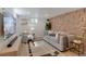 Modern living room featuring a stone accent wall, comfortable seating, and ample natural light at 9400 Ridge Rd, Arvada, CO 80002