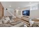 Open-concept living room features a staircase and a large TV at 9400 Ridge Rd, Arvada, CO 80002