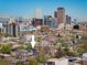 Denver home with city skyline and snow-capped mountains in the distance at 1050 N Clarkson St, Denver, CO 80218