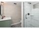 Renovated bathroom features white marble shower, green vanity, and modern fixtures at 1050 N Clarkson St, Denver, CO 80218