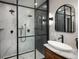Modern bathroom featuring walk-in shower with black trim and marble accent wall at 1050 N Clarkson St, Denver, CO 80218