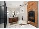 Luxurious bathroom with a freestanding tub, brick fireplace, and modern chandelier at 1050 N Clarkson St, Denver, CO 80218