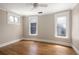 Neutral bedroom featuring gleaming hardwood floors, white trim and three windows at 1050 N Clarkson St, Denver, CO 80218