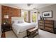 Bright bedroom featuring exposed brick wall, with natural light creating a warm, inviting atmosphere at 1050 N Clarkson St, Denver, CO 80218