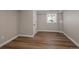 Neutral-toned basement bedroom with hardwood flooring, window, and white trim throughout at 1050 N Clarkson St, Denver, CO 80218