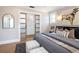 Bright bedroom with wood floors, a decorative mirror, and frosted glass sliding doors at 1050 N Clarkson St, Denver, CO 80218