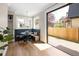Bright breakfast nook featuring a built-in bench, round table, and sliding glass doors to the outdoor deck at 1050 N Clarkson St, Denver, CO 80218