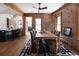 Open dining room with exposed brick, wood trim, and seamless flow to kitchen at 1050 N Clarkson St, Denver, CO 80218