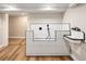 Tiled dog wash station featuring black fixtures and adjacent retro sink for easy pet care at 1050 N Clarkson St, Denver, CO 80218