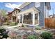 Charming blue two-story home with covered front porch, well-manicured landscaping, and inviting curb appeal at 1050 N Clarkson St, Denver, CO 80218