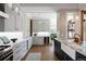 Bright, modern kitchen features white cabinetry, farmhouse sink, and hardwood floors at 1050 N Clarkson St, Denver, CO 80218