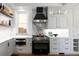 Gourmet kitchen with professional-grade appliances, custom cabinets, and stone backsplash at 1050 N Clarkson St, Denver, CO 80218