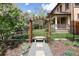 Beautiful pergola bench, surrounded by lush landscaping, making an inviting entry at 1050 N Clarkson St, Denver, CO 80218