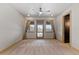 Bright bedroom features neutral carpet, ceiling fan, and glass doors to the outdoor living space at 1039 Buffalo Ridge Way, Castle Pines, CO 80108