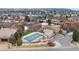 Overhead view of a pool with a covered roof and nearby parking at 1039 Buffalo Ridge Way, Castle Pines, CO 80108