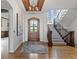 Grand foyer with hardwood floors, wood ceiling accents, staircase, and a decorative chandelier at 1039 Buffalo Ridge Way, Castle Pines, CO 80108