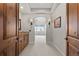 Hallway view to Primary bedroom with marble countertop vanity and sconce lighting at 1039 Buffalo Ridge Way, Castle Pines, CO 80108