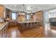 Spacious kitchen with an island, custom wood cabinetry, granite countertops, and recessed lighting at 1039 Buffalo Ridge Way, Castle Pines, CO 80108