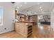 Open kitchen featuring an island and views of the living room with a fireplace at 1039 Buffalo Ridge Way, Castle Pines, CO 80108