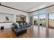 Spacious living room features large windows, hardwood floors, and open access to the kitchen at 1039 Buffalo Ridge Way, Castle Pines, CO 80108