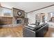 Cozy living room with stone fireplace, built-in cabinets, hardwood floors, and natural light at 1039 Buffalo Ridge Way, Castle Pines, CO 80108