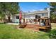 Backyard view of the deck with outdoor seating, and a lush lawn at 9376 W Wagon Trail Cir, Littleton, CO 80123