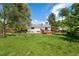Expansive backyard with lush green grass and a charming wooden deck at 9376 W Wagon Trail Cir, Littleton, CO 80123