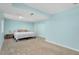 Light blue bedroom with neutral carpet, a large bed and a side table with lamps at 9376 W Wagon Trail Cir, Littleton, CO 80123